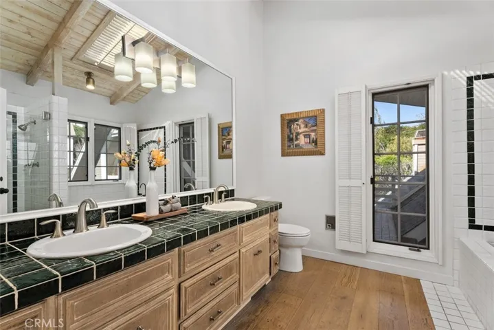 The primary bathroom includes a dual vanity sink, shower, tub, and just outside is a walk-in closet.