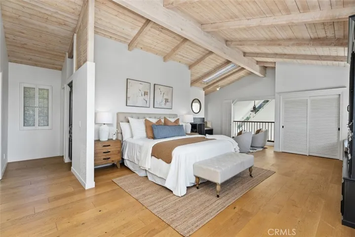 The spacious primary bedroom suite located upstairs. Vaulted ceilings and ocean views make this quite it's own special area.