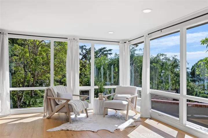 A serene corner in the bonus room with wonderful natural light and views of the garden.