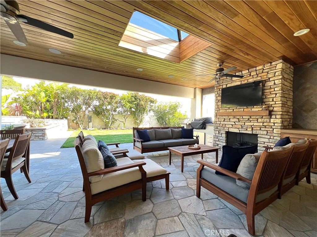 Spacious loggia with large grass area, just off the kitchen complete with grill, fireplace and TV.