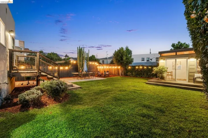 Fenced backyard featuring a patio and a deck