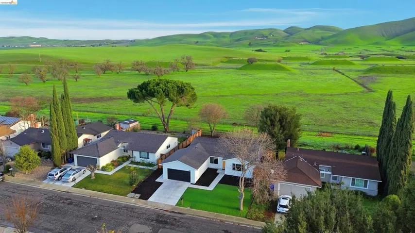 Overview of rural landscape with a mountainous background and nearby suburban area