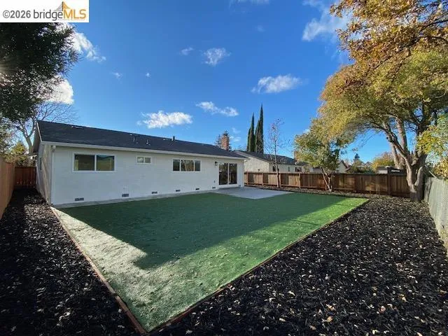 Back of property featuring a patio area, a fenced backyard, and crawl space