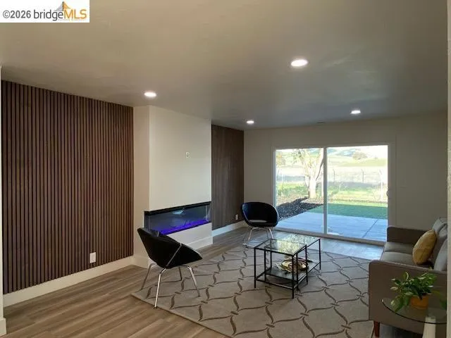Living room featuring light wood finished floors and recessed lighting