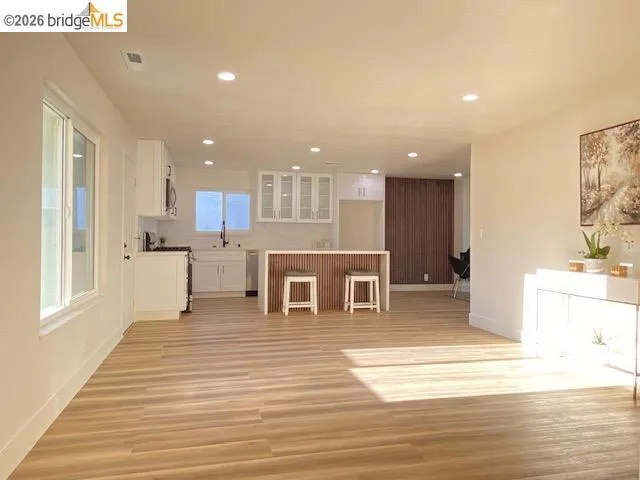 Unfurnished living room featuring light wood-type flooring and recessed lighting