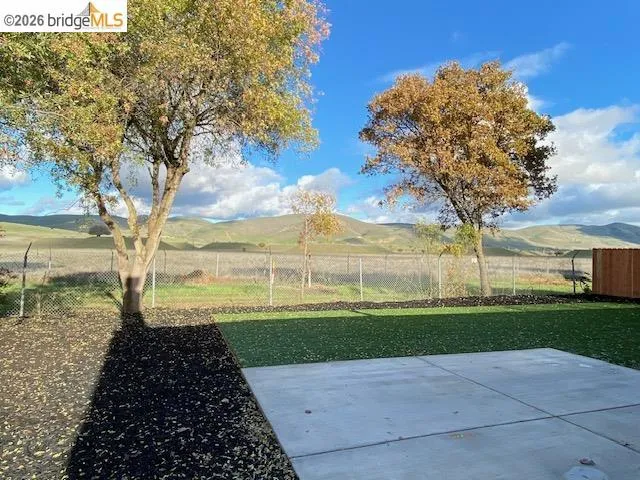 View of yard featuring a patio and a mountain view