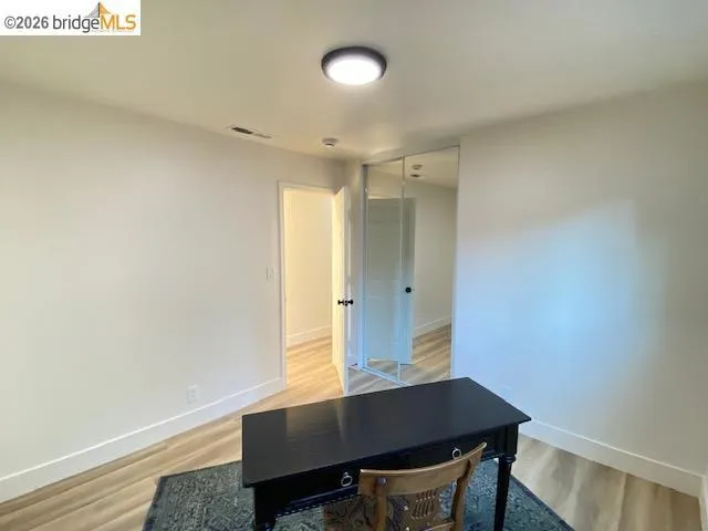 Home office featuring light wood finished floors and baseboards