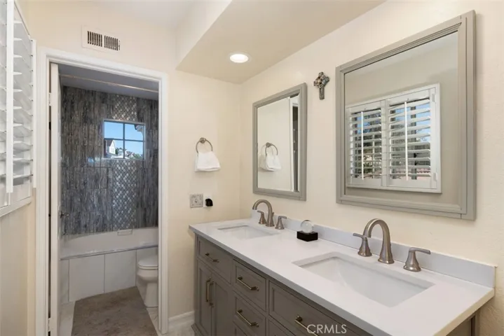 Beautifully upgraded primary bathroom with dual vanities.