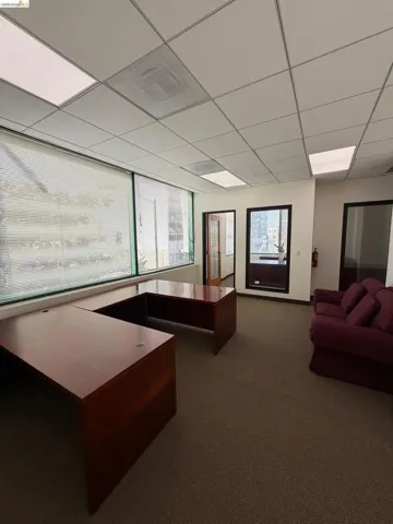 Home office with healthy amount of natural light and a paneled ceiling