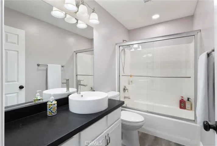 Full downstairs bathroom with tub and shower doors.