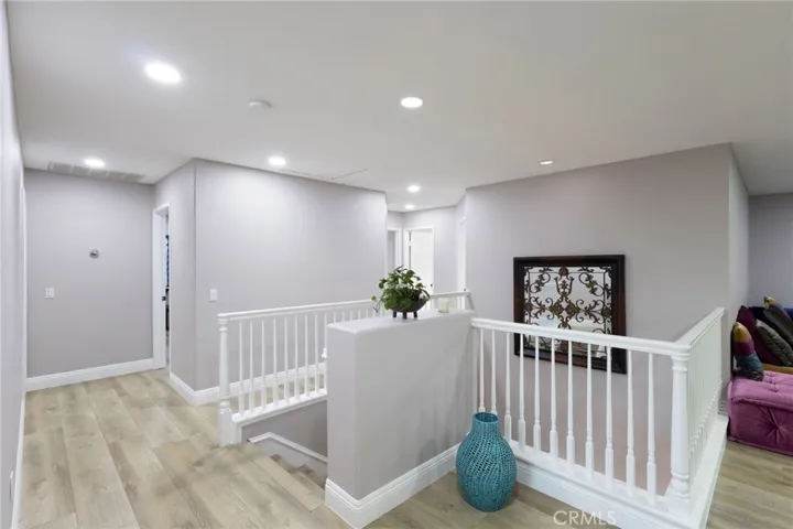 Standing in front of the master bedroom, looking at the other four bedrooms with the giant upstairs loft on the right most side.