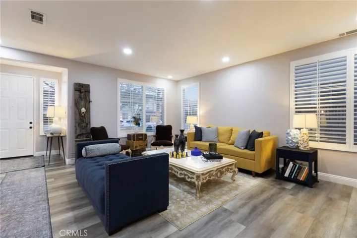 View of the formal living room, staircase to the left and looking at the front door.