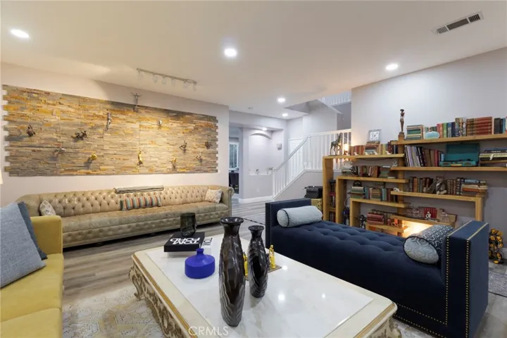 Formal living. The hallway leads to the kitchen and separate family room. The door by the staircase is a spacious downstairs coat closet or storage closet.