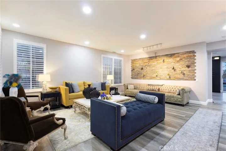 Formal living room view from foyer, kitchen dining and another family room through the hallway on the right side.