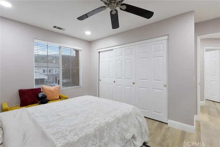 Fifth bedroom, with three door closet view.
