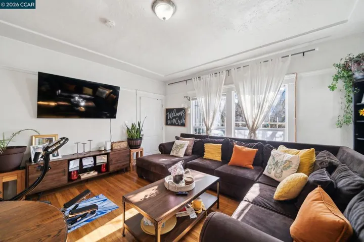 Living area with hardwood flooring and dual-pane windows