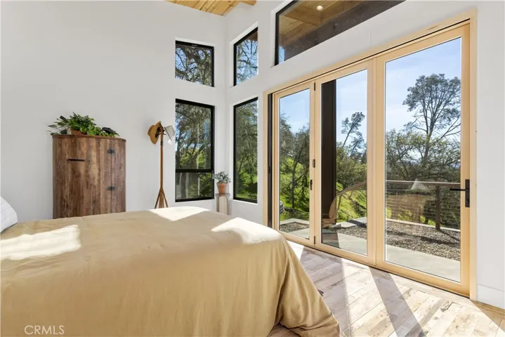 primary bedroom with retractable glass doors that open the wall to outdoors