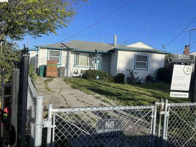Bungalow-style home with a fenced front yard and a gate