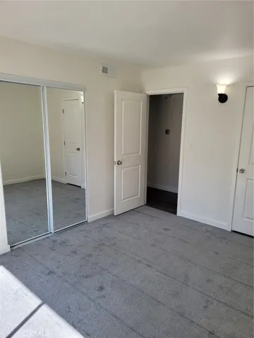 Bedroom 2 with mirrored closet doors