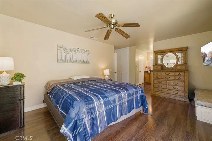 Roomy primary bedroom with walk in closet, private commode and shower in tub from the sink.
