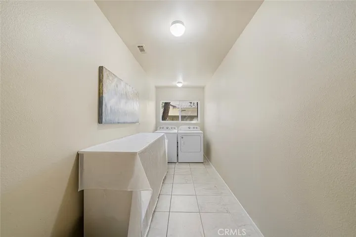 Very roomy indoor laundry. One could put shelves along the wall for extra pantry storage.