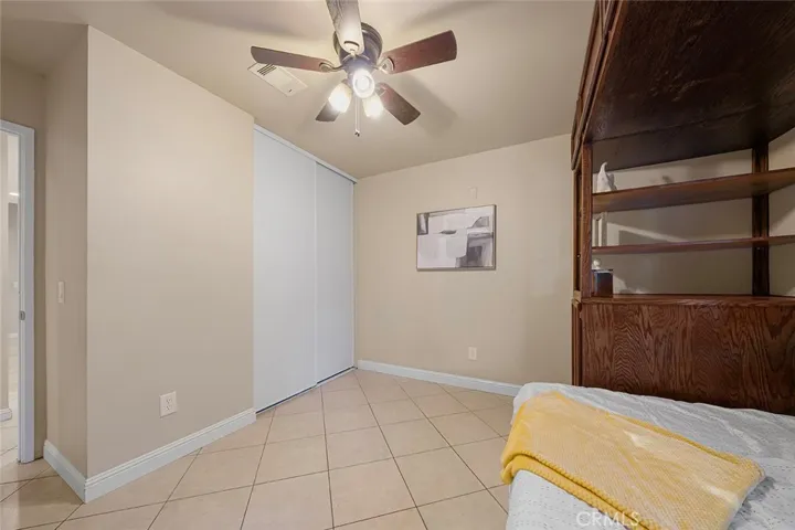 Two of four bedrooms with built ins and ceiling fan.