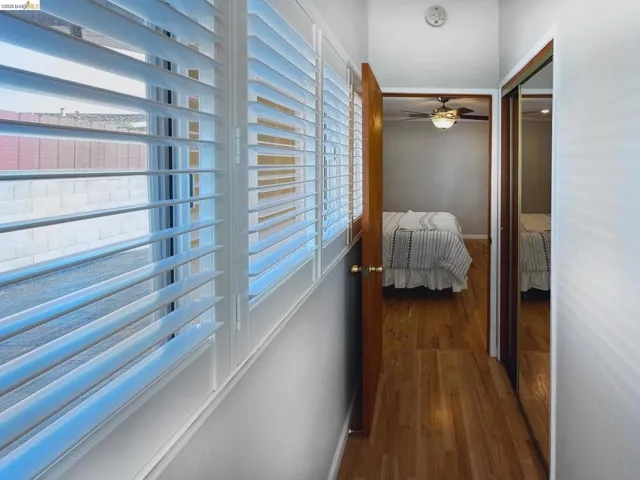 Hallway featuring dark wood-type flooring