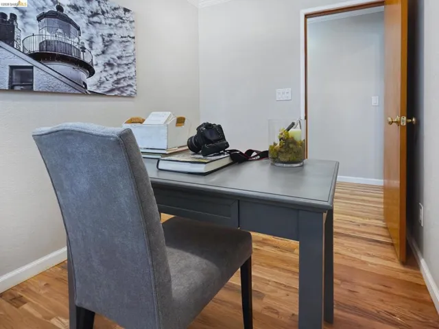 Home office featuring light wood finished floors and ornamental molding