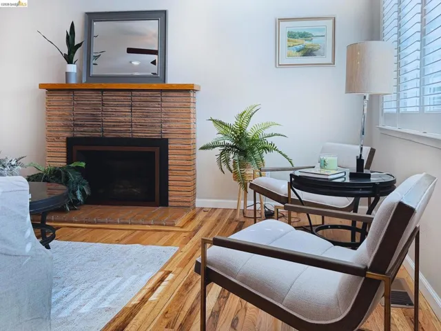 Living room featuring light wood-style floors and a fireplace