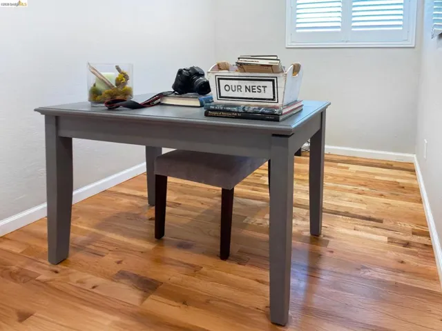 Home office with light wood finished floors