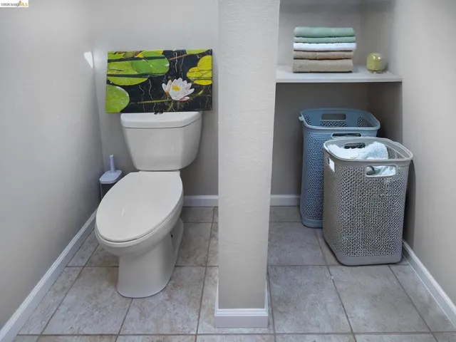 Bathroom featuring toilet and light tile patterned floors