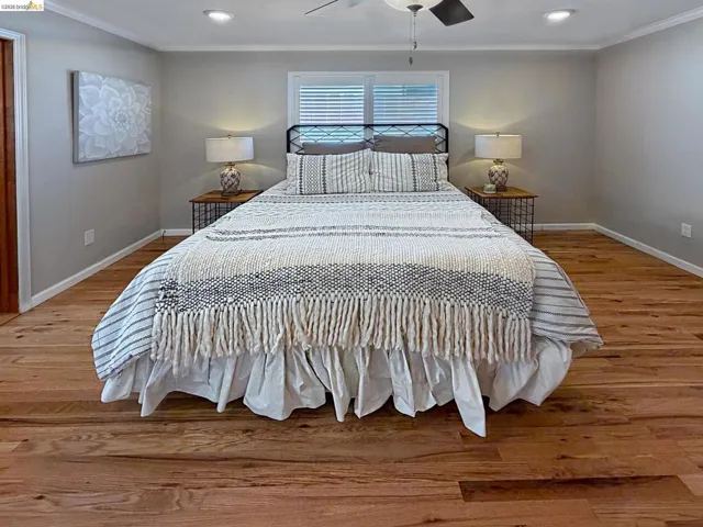 Bedroom with ornamental molding, light wood finished floors, a ceiling fan, and recessed lighting