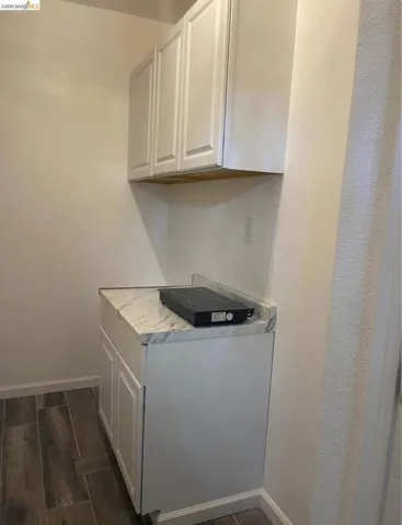Laundry room with wood finish floors and baseboards
