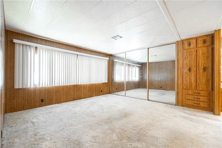 Primary Bedroom with Mirrored Closet Doors and Built in cupboards and drawers.