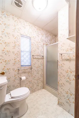 Primary bathroom with private toilet and walk in shower