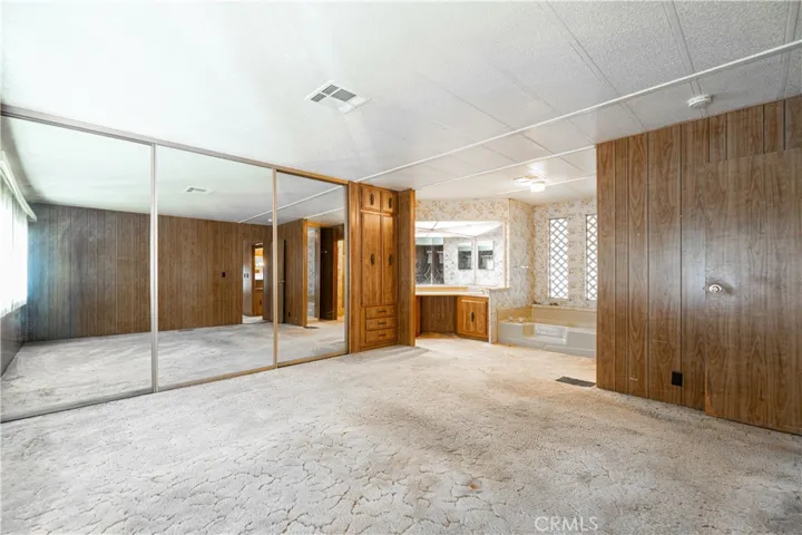 Primary bedroom with dual sinks, bathtub