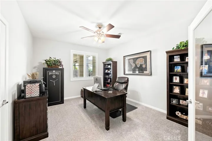 Versatile downstairs office or bedroom:
The downstairs office features elegant double doors, a ceiling fan, and a view overlooking the front courtyard, offering flexibility for use as a private workspace, guest room, or additional bedroom as needed. Thoughtfully positioned for convenience and privacy, it adapts beautifully to your lifestyle.