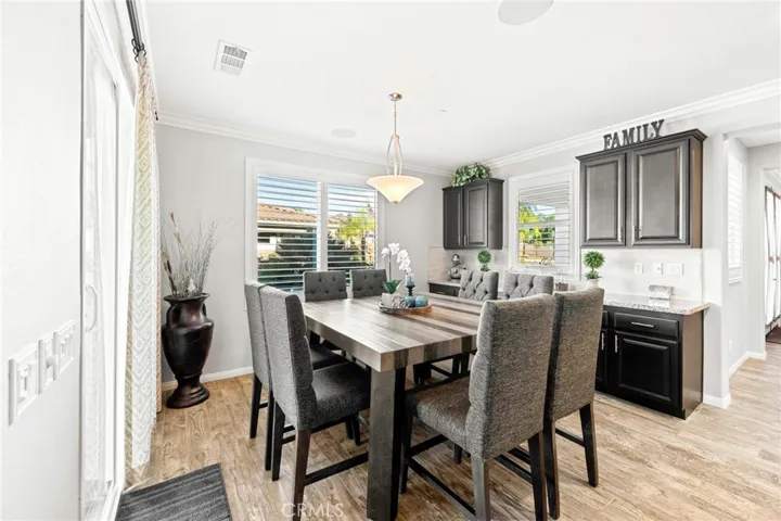 Luxurious custom kitchen and great room:
This expansive, open-concept great room showcases a designer kitchen with premium stainless-steel appliances, double ovens, sleek pendant lighting, and abundant cabinetry. A spacious island with generous counter seating anchors the space, seamlessly flowing into the elegant living area and a large dining niche—perfect for entertaining. Sliding glass doors open to the resort-style backyard, creating the ultimate indoor-outdoor living experience.