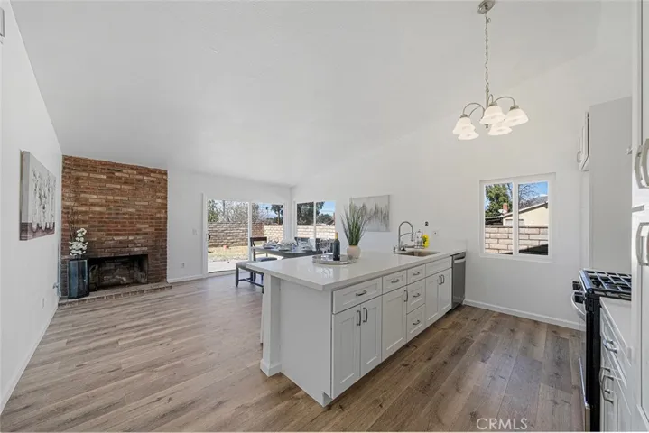 Fabulous updated kitchen with quartz counters and room to dine at the peninsula. Luxury vinyl plank flooring throughout. Newer double pane windows and slider. Corner fireplace adds warmth and charm. Soft close cabinets and drawers. New light fixture, sink, dishwasher and stove and hood.
