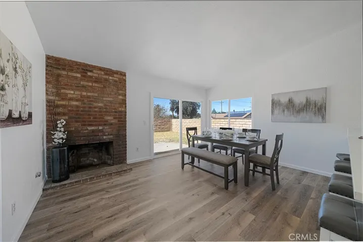 Spacious area to dine off from the kitchen and room for more. Large peninsula counter can accommodate four comfortably. Brick fireplace adds character and charm to the room.