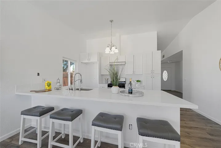 Roomy peninsula with quartz counter and sink. Seating can be upto 4 comfortably.