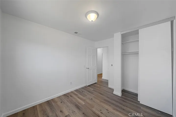One of three bedrooms newly painted, new flooring, lighting.