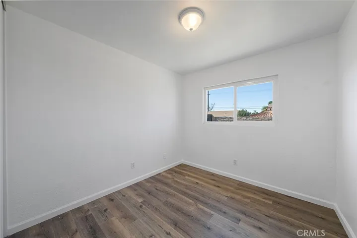 One of three bedrooms newly painted, new flooring, lighting.