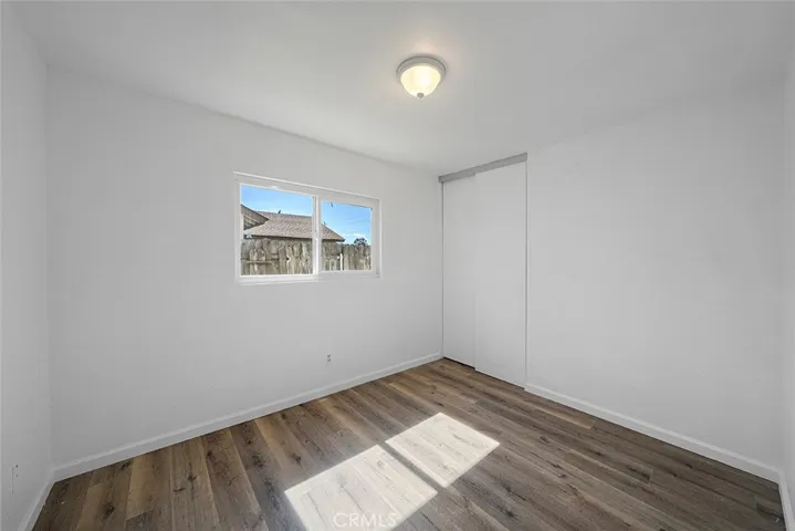One of three bedrooms newly painted, new flooring, lighting. This one is located first on the left hand side of the hallway across from the hallway bathroom.
