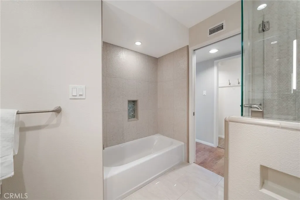 Tub and shower are separate in the secondary bath.