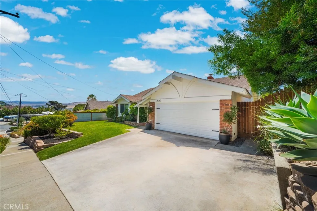 Another view of the front so you can see there is lot of parking space. The 2 large pots out front convey with the home.