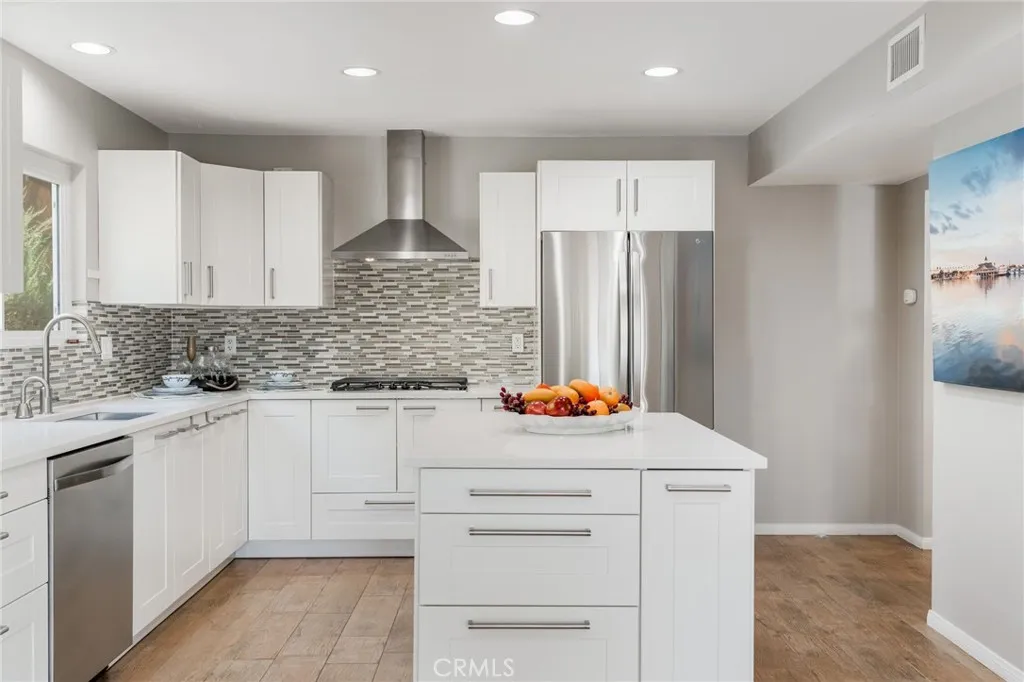 There is space to right of refrigerator to build in shelves or a rack to create more storage space.