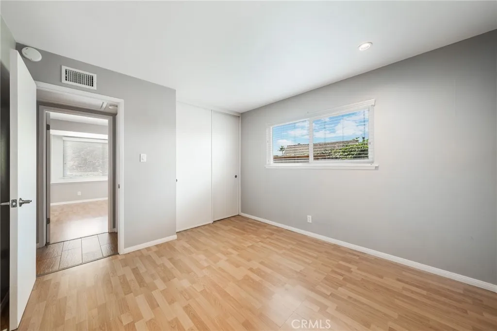 Looking from bedroom 3 across hallway to Front Bedroom 2. The large Window Seat can be seen in the front room.