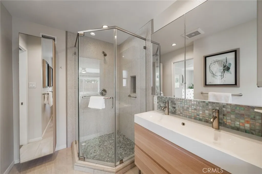 Primary Bath includes a mirrored closet, walk-in shower and dual sinks.