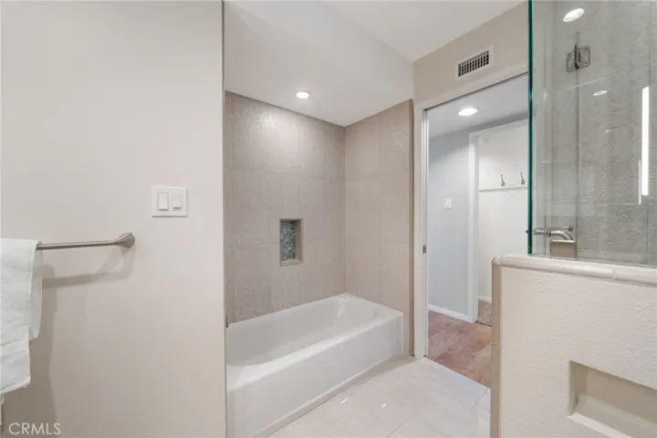 Tub and shower are separate in the secondary bath.